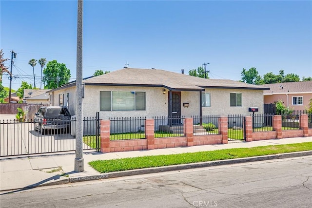 1510 E 53rd St, Long Beach, CA 90805 - bungalow-style house with stucco siding, a fenced front yard, and roof with shingles