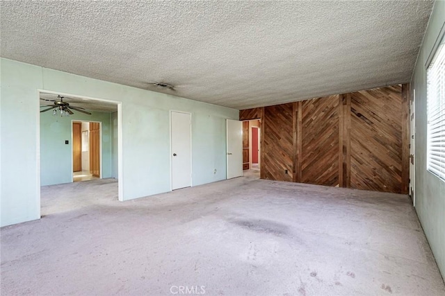 1510 E 53rd St, Long Beach, CA 90805 - unfurnished living room featuring carpet, wood walls, and a textured ceiling
