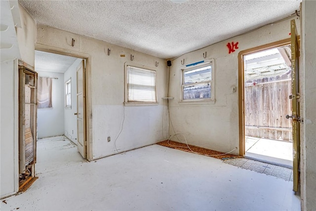 1510 E 53rd St, Long Beach, CA 90805 - unfurnished room featuring plenty of natural light, a textured ceiling, and concrete floors