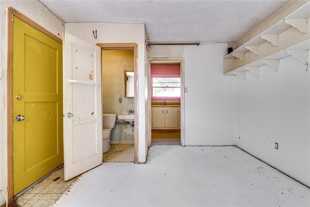 1510 E 53rd St, Long Beach, CA 90805 - unfurnished bedroom with a textured ceiling, unfinished concrete floors, and ensuite bathroom