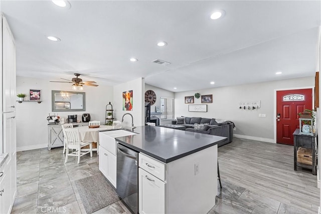 6057 Azalea St, Chino, CA 91710 - kitchen with dishwasher, a center island with sink, dark countertops, white cabinets, and recessed lighting
