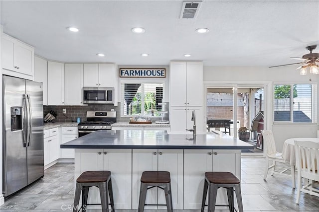 6057 Azalea St, Chino, CA 91710 - kitchen featuring appliances with stainless steel finishes, a kitchen breakfast bar, backsplash, a center island, and recessed lighting