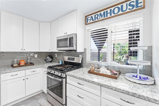 6057 Azalea St, Chino, CA 91710 - kitchen with appliances with stainless steel finishes, tasteful backsplash, white cabinetry, and light stone counters