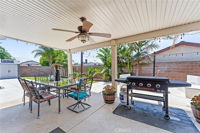 6057 Azalea St, Chino, CA 91710 - fenced backyard featuring outdoor dining space, a patio area, a storage shed, and a ceiling fan