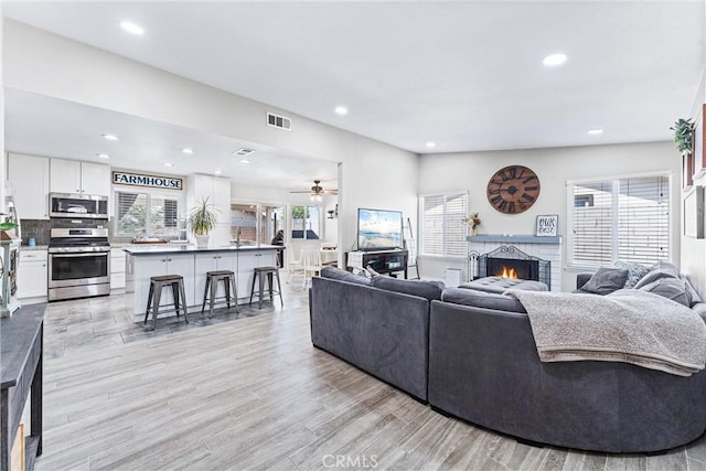 6057 Azalea St, Chino, CA 91710 - living area with a brick fireplace, recessed lighting, a ceiling fan, and light wood finished floors