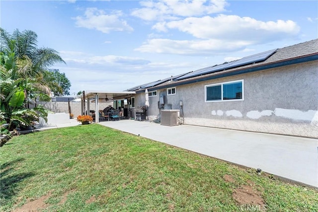 6057 Azalea St, Chino, CA 91710 - back of house with stucco siding, solar panels, a fenced backyard, and a patio