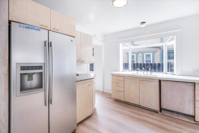 275 Euclid Ave, Long Beach, CA 90803 - kitchen with stainless steel fridge with ice dispenser, light wood-style floors, light brown cabinetry, and tile countertops