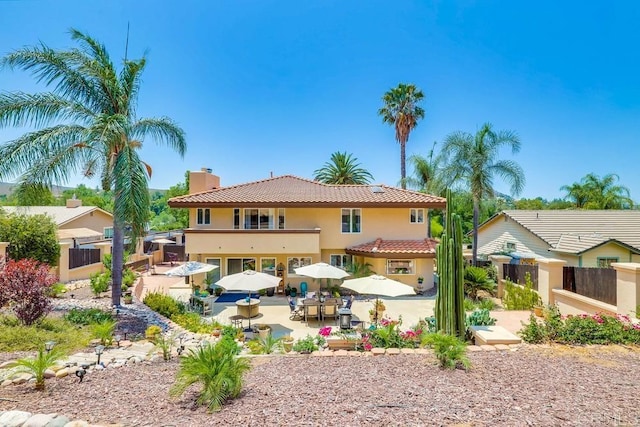 25322 Poderio Dr, Ramona, CA 92065 - back of property featuring stucco siding, a patio, a balcony, a chimney, and a tile roof