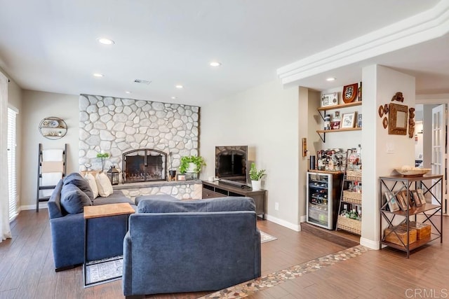 25322 Poderio Dr, Ramona, CA 92065 - living room featuring wine cooler, wood finished floors, a stone fireplace, and recessed lighting