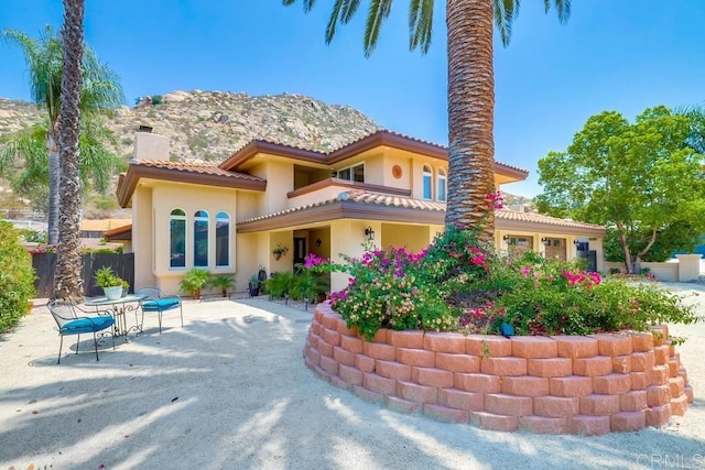 25322 Poderio Dr, Ramona, CA 92065 - view of front of property with a chimney, stucco siding, a patio, and a tiled roof
