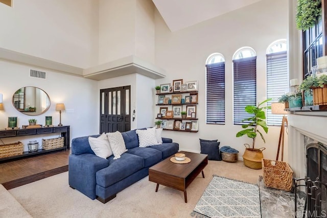25322 Poderio Dr, Ramona, CA 92065 - living room featuring a fireplace, a high ceiling, and wood finished floors