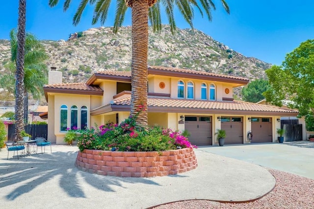 25322 Poderio Dr, Ramona, CA 92065 - mediterranean / spanish home featuring a chimney, a mountain view, stucco siding, driveway, and a tiled roof