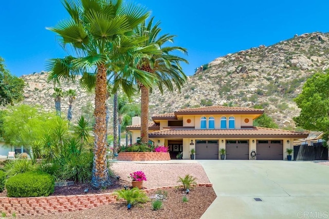25322 Poderio Dr, Ramona, CA 92065 - mediterranean / spanish-style home with stucco siding, driveway, and a tiled roof