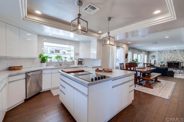 25322 Poderio Dr, Ramona, CA 92065 - kitchen with stainless steel dishwasher, black electric stovetop, a tray ceiling, dark wood-style flooring, and recessed lighting