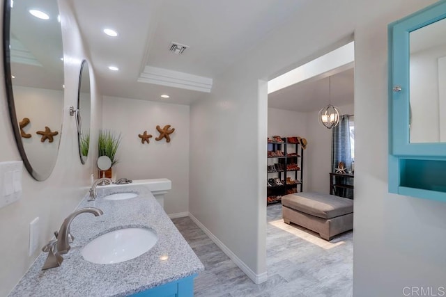 25322 Poderio Dr, Ramona, CA 92065 - bathroom with double vanity, recessed lighting, and wood finished floors