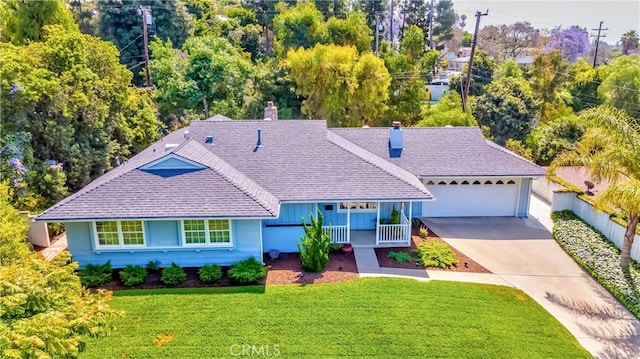 9858 Cullman Ave, Whittier, CA 90603 - view of front of house with a chimney, a front yard, driveway, a shingled roof, and a garage