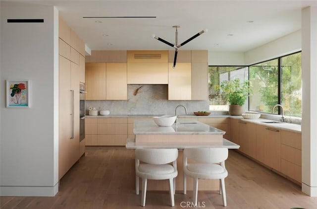 1105 Skyline Dr, Laguna Beach, CA 92651 - kitchen with a center island with sink, cooktop, light countertops, light brown cabinets, and modern cabinets