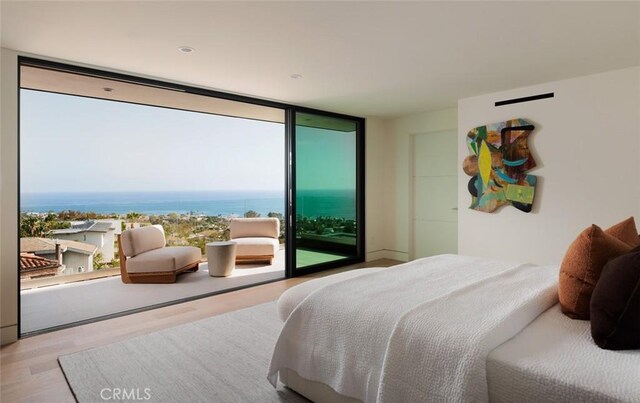 1105 Skyline Dr, Laguna Beach, CA 92651 - bedroom with wood finished floors, expansive windows, access to exterior, and a water view