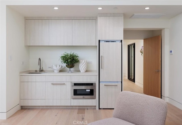 1105 Skyline Dr, Laguna Beach, CA 92651 - kitchen featuring paneled built in refrigerator, oven, modern cabinets, light countertops, and light wood-style flooring