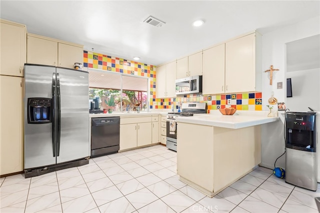 252 W Blaine St, Riverside, CA 92507 - kitchen with stainless steel appliances, cream cabinets, a peninsula, light countertops, and recessed lighting