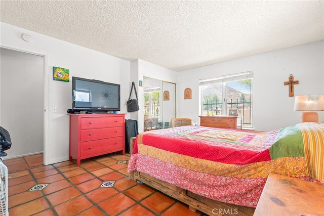 252 W Blaine St, Riverside, CA 92507 - bedroom featuring a textured ceiling, tile patterned flooring, and a closet