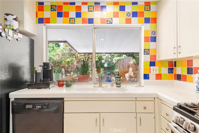 252 W Blaine St, Riverside, CA 92507 - kitchen featuring dishwasher, white cabinetry, tile countertops, and stainless steel range with gas cooktop
