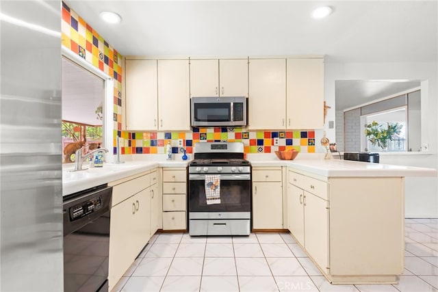 252 W Blaine St, Riverside, CA 92507 - kitchen with stainless steel appliances, cream cabinets, light countertops, a peninsula, and recessed lighting