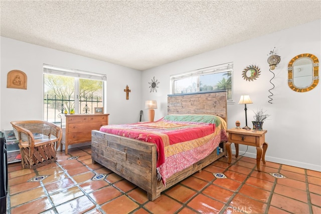 252 W Blaine St, Riverside, CA 92507 - bedroom with multiple windows, a textured ceiling, and tile patterned flooring