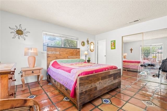252 W Blaine St, Riverside, CA 92507 - tiled bedroom featuring a textured ceiling and a closet