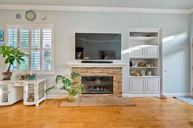 6707 Ketch Way, Carlsbad, CA 92011 - living area featuring wood finished floors, crown molding, built in features, and a fireplace