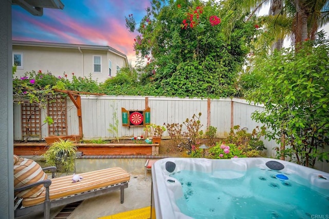 6707 Ketch Way, Carlsbad, CA 92011 - patio terrace at dusk featuring a hot tub and a fenced backyard