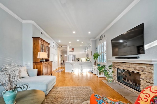6707 Ketch Way, Carlsbad, CA 92011 - living area featuring ornamental molding, light wood finished floors, a fireplace, and recessed lighting