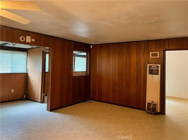 5128 W State Highway 20, Upper Lake, CA 95485 - spare room featuring a heating unit, wood walls, and ceiling fan