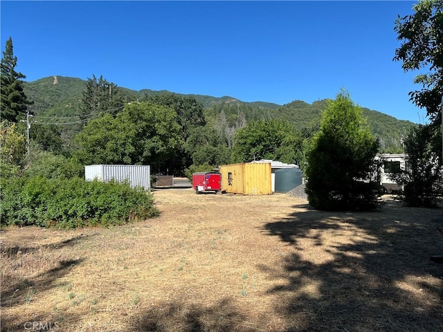 5128 W State Highway 20, Upper Lake, CA 95485 - view of yard with a mountain view, an outdoor structure, and a wooded view