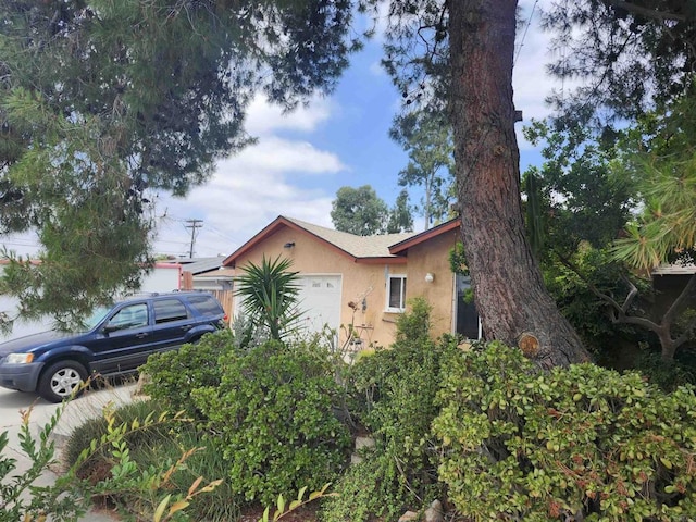 9408 Wharton Rd, Santee, CA 92071 - view of home's exterior with stucco siding and a garage