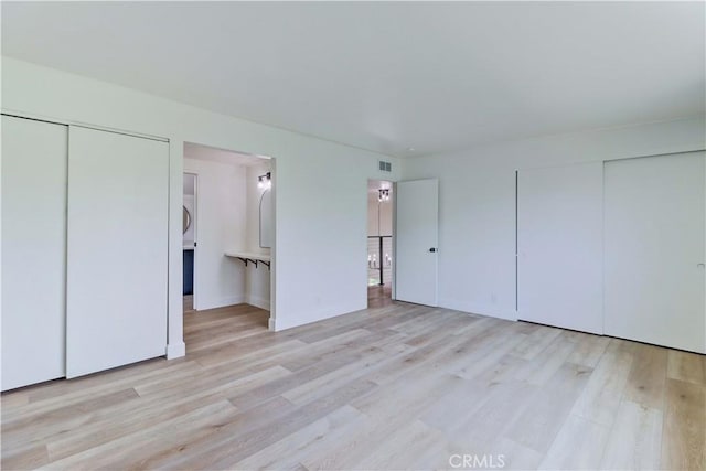 8312 Bellhaven St, La Palma, CA 90623 - unfurnished bedroom with wood finished floors, multiple closets, and ensuite bath