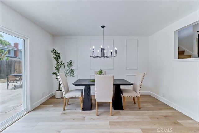 8312 Bellhaven St, La Palma, CA 90623 - dining room featuring a chandelier, light wood-type flooring, and stairs