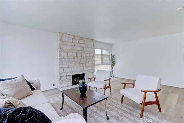 8312 Bellhaven St, La Palma, CA 90623 - living room with light wood-style flooring and a stone fireplace