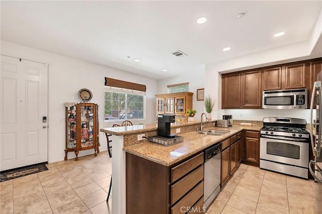 31170 Strawberry Tree Ln Unit 67, Temecula, CA 92592 - kitchen featuring appliances with stainless steel finishes, light stone countertops, a peninsula, recessed lighting, and light tile patterned floors