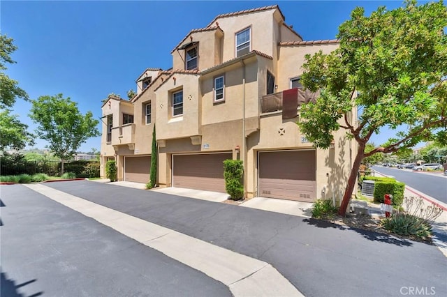 31170 Strawberry Tree Ln Unit 67, Temecula, CA 92592 - view of front of house featuring stucco siding, an attached garage, and a tile roof