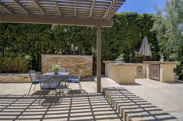 62 Gentry, Irvine, CA 92620 - view of patio featuring outdoor dining area, an outdoor kitchen, a pergola, and view of scattered trees