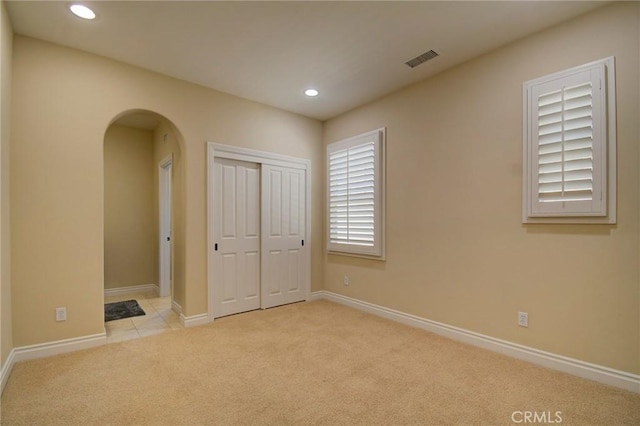 62 Gentry, Irvine, CA 92620 - unfurnished bedroom with arched walkways, carpet floors, recessed lighting, and a closet