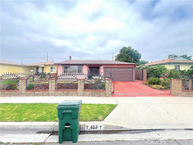 407 S Northwood Ave, Compton, CA 90220 - ranch-style house featuring a fenced front yard, a garage, and concrete driveway