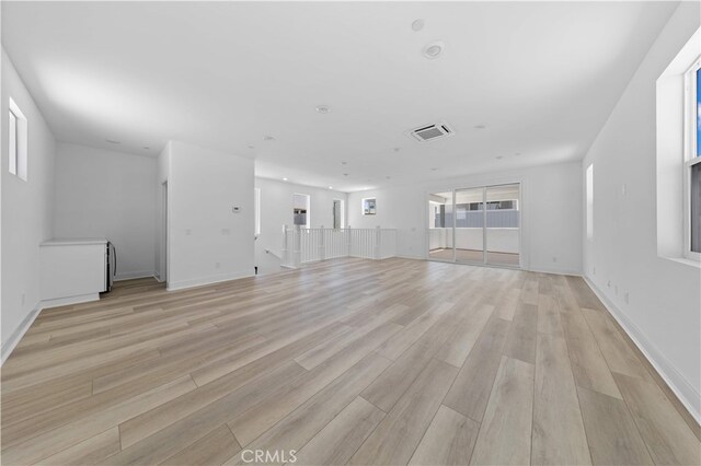 27216 W Coyote Bush Ct, Valencia, CA 91355 - unfurnished living room featuring light wood-style flooring and baseboards