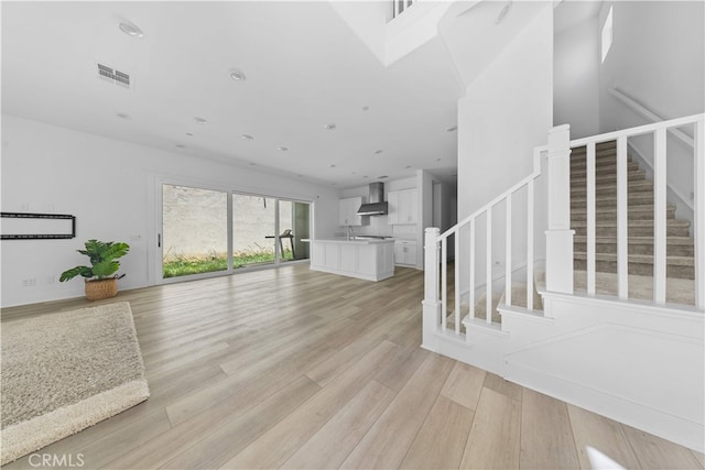 27216 W Coyote Bush Ct, Valencia, CA 91355 - unfurnished living room featuring stairs and light wood-style flooring