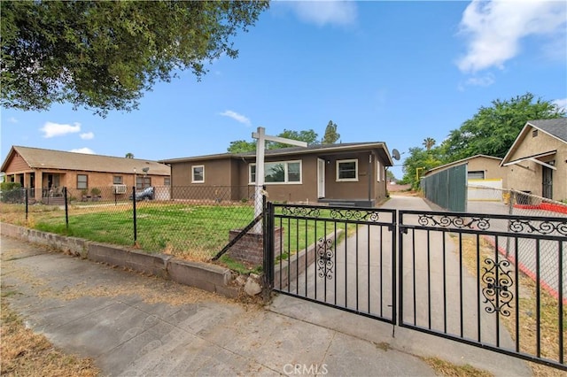 2058 N Pico Ave, San Bernardino, CA 92411 - ranch-style house featuring a fenced front yard, a gate, and stucco siding