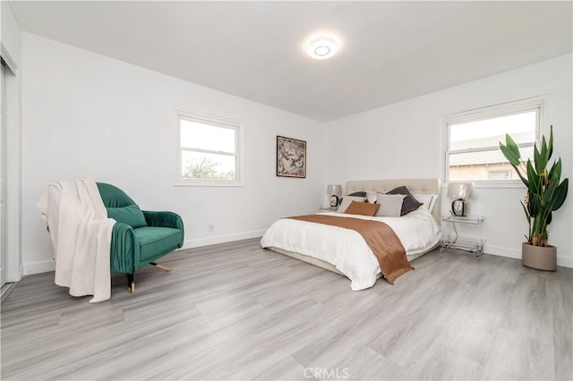 2058 N Pico Ave, San Bernardino, CA 92411 - bedroom with light wood finished floors and multiple windows