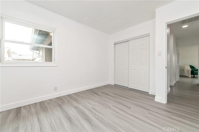 2058 N Pico Ave, San Bernardino, CA 92411 - unfurnished bedroom featuring light wood-style floors and a closet