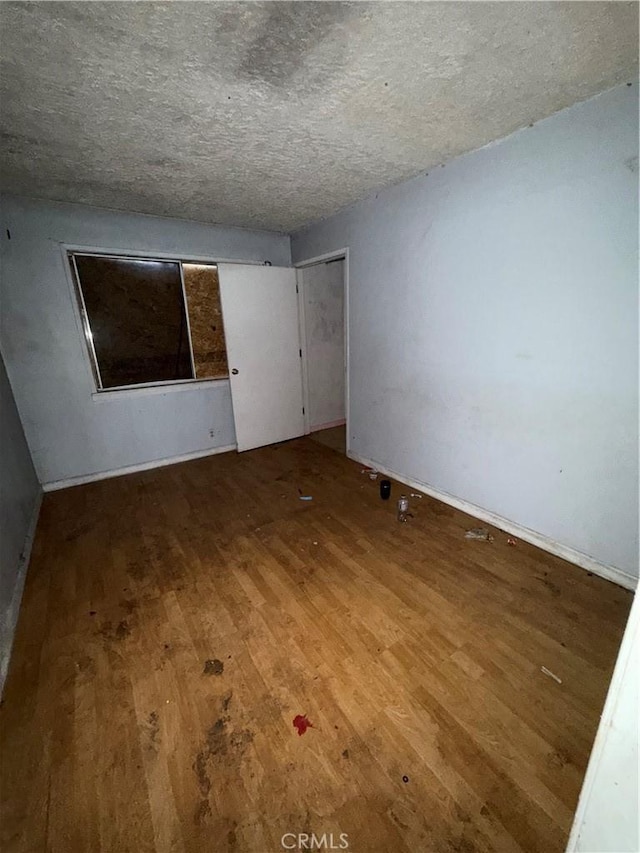 2915 Lanning Ave, Redding, CA 96001 - unfurnished bedroom with wood finished floors, a textured ceiling, and a closet