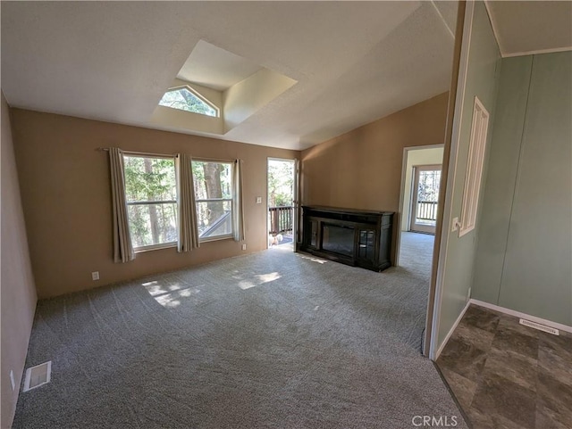 16121 Golf Rd, Cobb, CA 95426 - unfurnished living room with plenty of natural light, vaulted ceiling, a glass covered fireplace, a skylight, and carpet floors